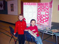 Conner Ashton (dressed in an RCMP uniform) and project partner Natazsa Johnston, pose in front of their joint effort.