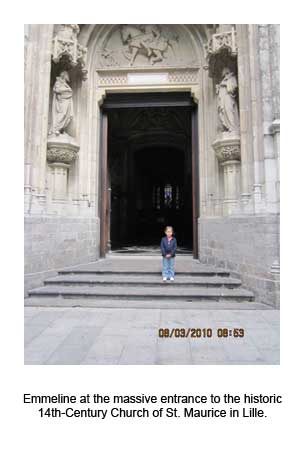 Emmeline at the massive entrance to the historic 14th-Century Church of St. Maurice in Lille