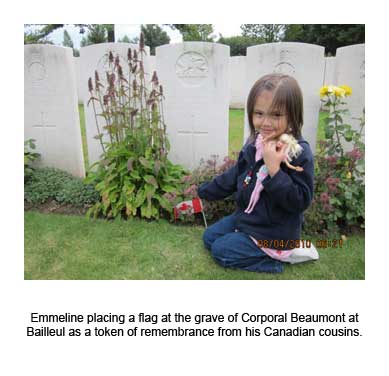 Emmeline placing a flag at the grave of Corporal Beaumont at Bailleul